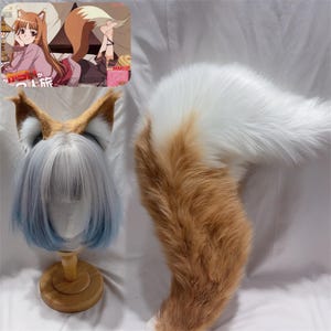 May include: A cosplay set featuring a fox tail and ears. The tail is white and orange, made of faux fur. The ears are brown and white, attached to a headband. A wig with blue and white hair is also included.