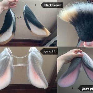 May include: A collection of faux fur animal ears in various color patterns. The black brown set features black, white, and tan fur. The gray pink set displays light gray fur with pink inner accents, shown both on a clear stand and held by hand.