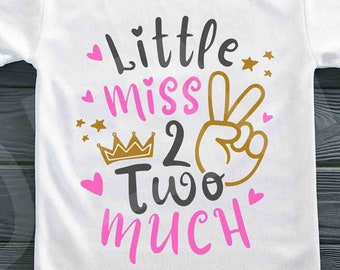May include: White t-shirt with a pink and gold graphic that says "Little miss 2 two much" with a crown and a peace sign.