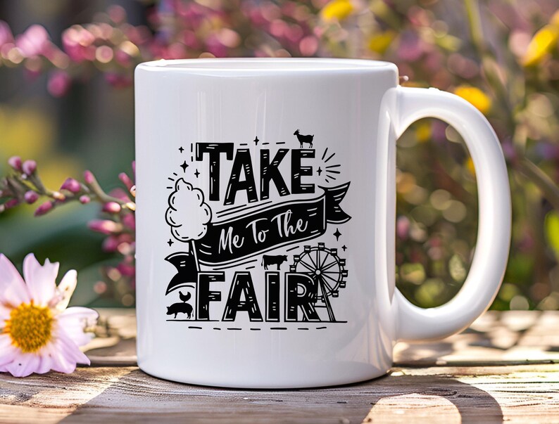 May include: White ceramic mug with a black design that says "Take Me To The Fair" with a cartoon cotton candy, pig, and Ferris wheel.