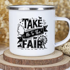 May include: White enamel mug with a black graphic that says "Take Me To The Fair" with a cartoon cotton candy, pig, and Ferris wheel.
