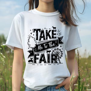 May include: White t-shirt with black text that reads "Take Me To The Fair" with a graphic of a cotton candy stand, a Ferris wheel, and farm animals.