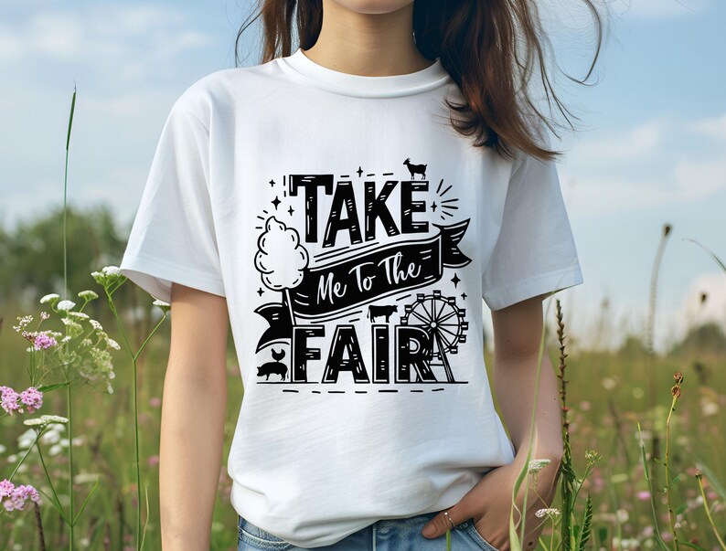 May include: White t-shirt with black text that reads "Take Me To The Fair" with a graphic of a cotton candy stand, a Ferris wheel, and farm animals.