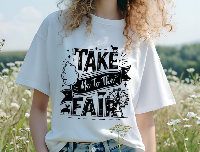 May include: White t-shirt with black text that reads "Take Me To The Fair" with a graphic of a Ferris wheel, a pig, and a cotton candy stand.