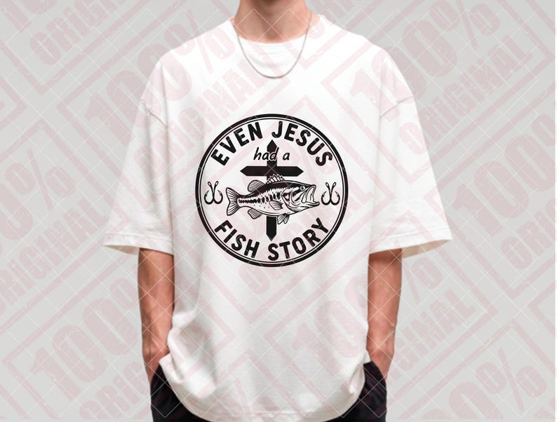 May include: White t-shirt with a black graphic. The graphic features a fish, cross, and the text "EVEN JESUS had a FISH STORY" in a circular design. The shirt has short sleeves and a relaxed fit.