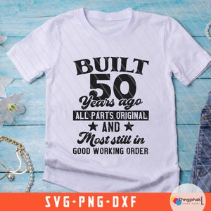 May include: White t-shirt with black text that reads "BUILT 50 Years ago ALL PARTS ORIGINAL AND Most still in GOOD WORKING ORDER".