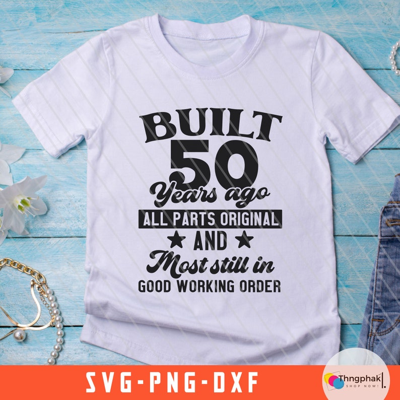 May include: White t-shirt with black text that reads "BUILT 50 Years ago ALL PARTS ORIGINAL AND Most still in GOOD WORKING ORDER".