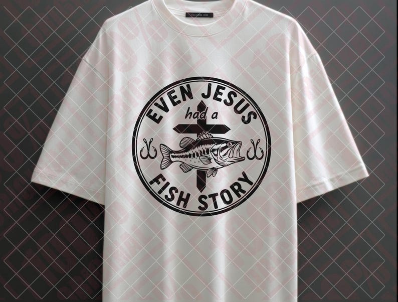May include: White t-shirt with a black graphic. The graphic is a circular design with the words "EVEN JESUS had a FISH STORY" around a cross and a fish. The shirt has short sleeves and a crew neck.