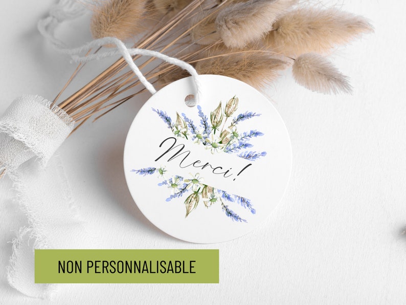 May include: Round white tag with a watercolor illustration of lavender flowers and the word "Merci!" in black script.
