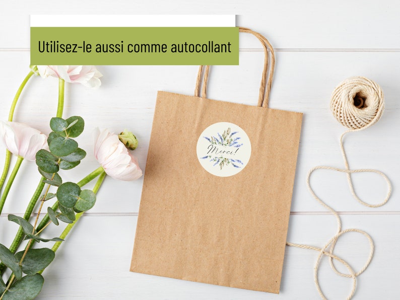 May include: A brown paper gift bag with a round sticker that says "Merci!" in black script. The sticker has a watercolor design of blue flowers and green leaves.