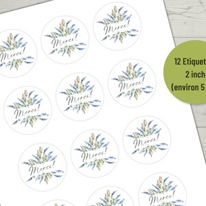 May include: Twelve 2-inch round stickers with a watercolor design of blue and green flowers and the word "Merci!" in black script.
