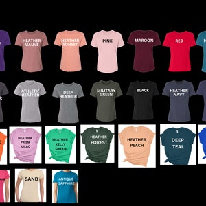May include: A chart of 24 different coloured t-shirts with text labels for each colour. The colours include team purple, heather mauve, heather sunset, pink, maroon, red, heather deep teal, dark grey heather, athletic heather, deep heather, military green, black, heather navy, navy, orange, heather prism lilac, heather kelly green, heather forest, heather peach, deep teal, true royal, heliconia, sand, and antique sapphire.