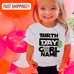 May include: White t-shirt with a black and green graphic of a character from the Star Wars franchise. The text "BIRTH DAY 3 GIRL NAME" is printed on the shirt.