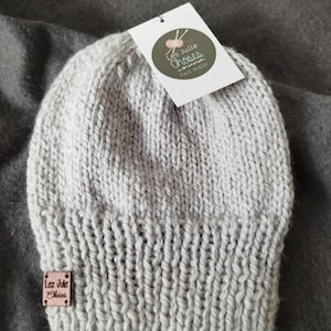 Peut inclure: Un bonnet en tricot gris avec une étiquette en cuir marron qui dit "Les Julie Choses Fait main".