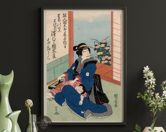 May include: A vintage Japanese woodblock print depicting a woman in a blue kimono holding a child. The woman is sitting on a floor with a window behind her. The print is titled "鼓人國太師追着狂言" in Japanese.