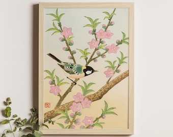May include: A framed print of a traditional Japanese painting depicting a small bird perched on a branch of a flowering tree with pink blossoms. The background is a soft yellow.