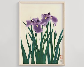May include: A framed print of a Japanese-style painting featuring two purple iris flowers with green leaves and a single bud. The print has a cream background and a red seal in the bottom right corner.