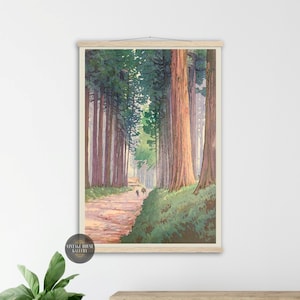 May include: A framed print of a forest path lined with tall trees. The artwork features a path leading into the distance, with figures walking towards a small building. The color palette includes greens, browns, and a touch of yellow.