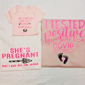 May include: A set of three pink and white shirts with a pregnancy announcement theme. The baby onesie says "My parents did not social distance 2021". The larger shirt says "She's pregnant but I did all the work". The third shirt says "I tested positive but not for COVID" with a pregnancy test and footprints.