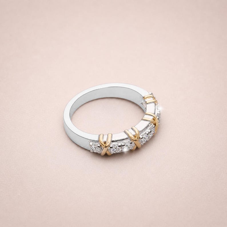 Shop our sixteen stone moissanite full eternity band. This unique two tone X cross wedding ring in gold vermeil features a brilliant criss cross design. The perfect stackable anniversary band, designer promise ring, or bridal jewelry for women.