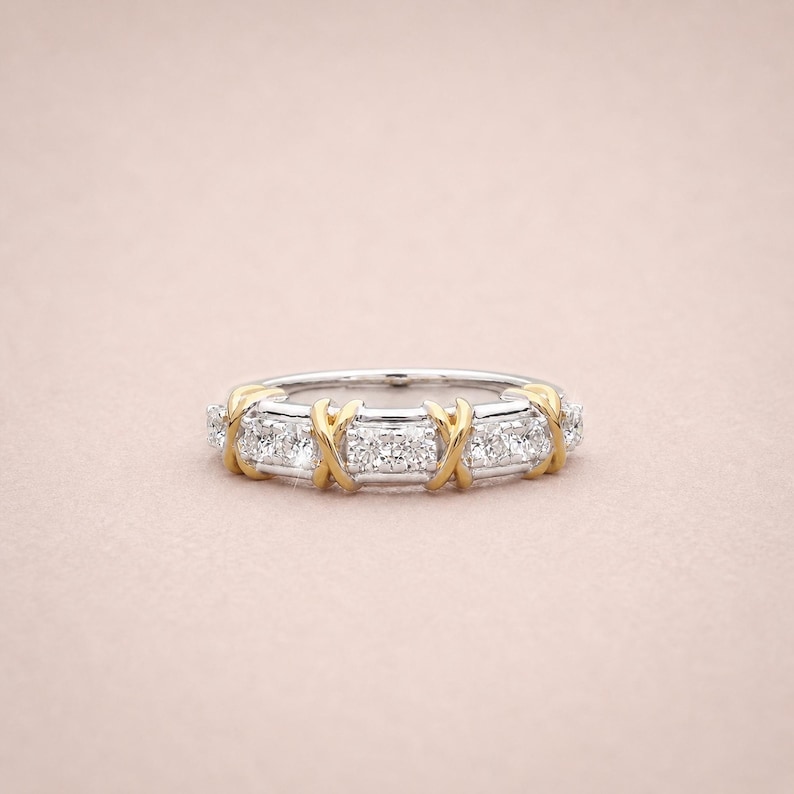 Shop our sixteen stone moissanite full eternity band. This unique two tone X cross wedding ring in gold vermeil features a brilliant criss cross design. The perfect stackable anniversary band, designer promise ring, or bridal jewelry for women.