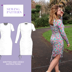 May include: A sewing pattern for a long-sleeved dress with a gathered skirt and tie closures at the hem. The pattern includes written and video instructions. "Sewing Pattern" is written on a white card.