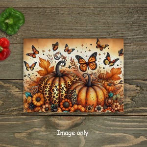 May include: Two decorative pumpkins with a leopard print and orange paint, surrounded by butterflies and flowers. The pumpkins are on a brown background.
