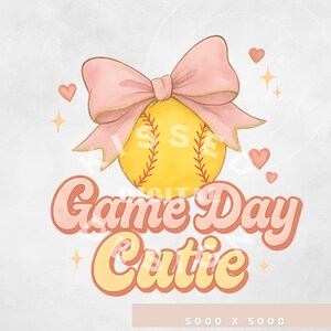 May include: A watercolour design featuring a yellow softball with red stitching, topped with a pink bow. The text "Game Day Cutie" is in a retro font, with hearts and stars accents. A cute design for softball fans.