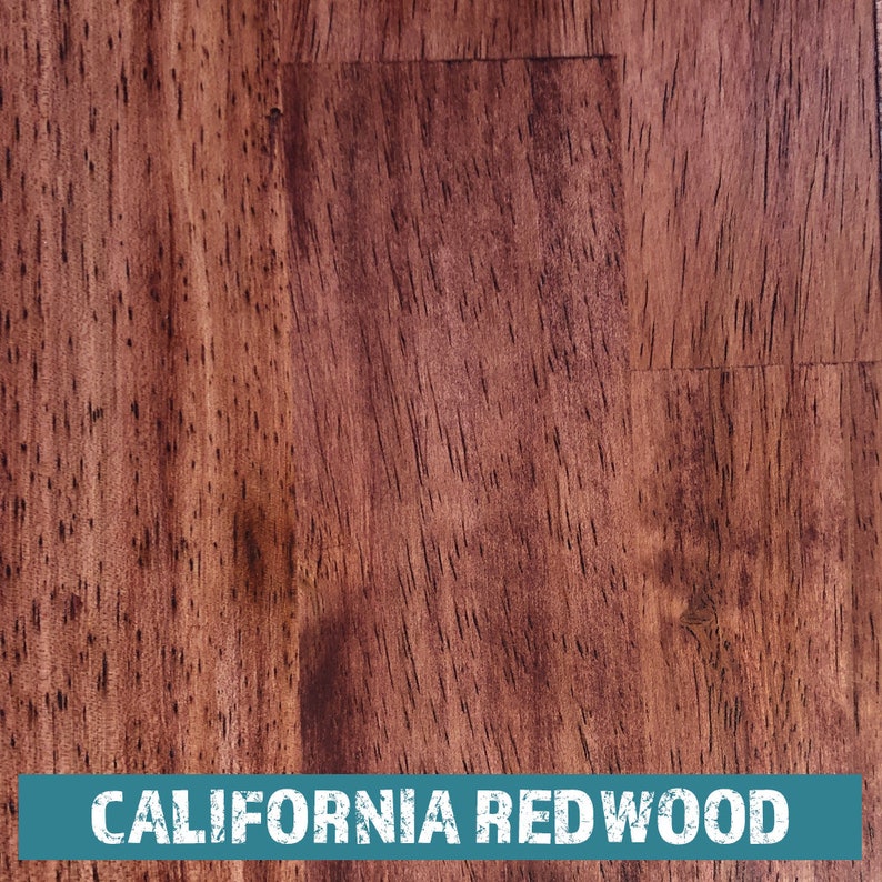 May include: Close-up of a rich, reddish-brown wood grain surface. The wood has a natural, rustic look with a subtle sheen. The text "CALIFORNIA REDWOOD" is printed in white on a teal blue background at the bottom of the image.