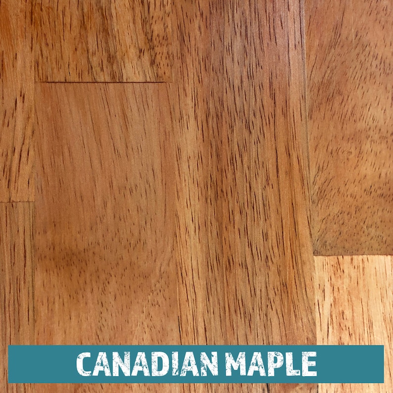May include: Close-up of a light brown wood grain surface with the text "CANADIAN MAPLE" printed in white on a teal blue background.