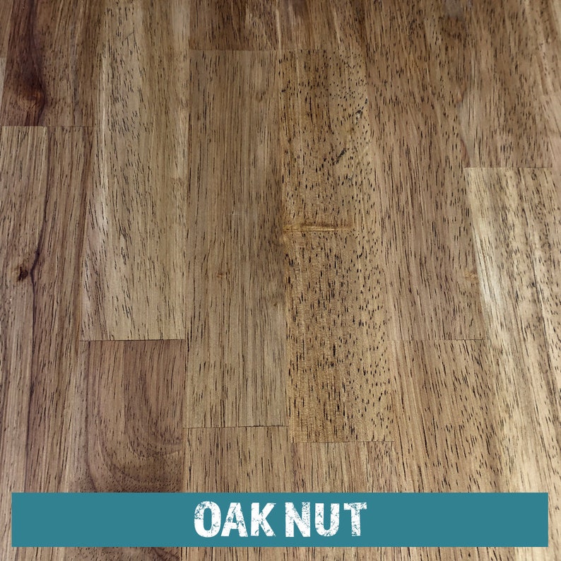 May include: Close-up of a wood grain surface with a light brown color. The wood has a natural, knotty texture. The text "OAK NUT" is printed in white on a teal blue background at the bottom of the image.