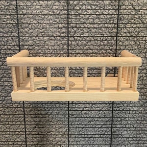 May include: A wooden bird feeder with a round opening and a railing around the top. The feeder is made of natural wood and has a rustic look.