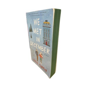 We Met in December paperback with painted edges
