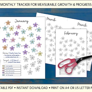 May include: A monthly tracker printable with floral designs. The January page features colorful flower illustrations for each day, with focus and target sections. The text reads "MONTHLY TRACKER FOR MEASURABLE GROWTH & PROGRESS". Includes a pair of scissors and a cup of tea.