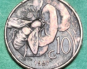 May include: A silver Italian coin with a bee on a flower and the text "10 c. 1997" on the back.