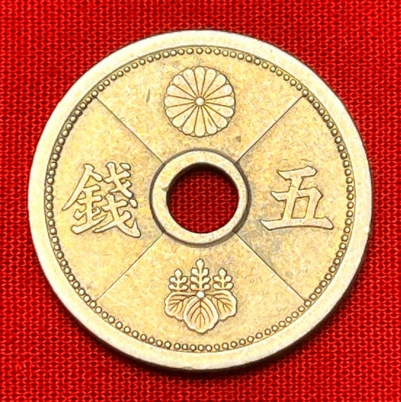 One Japanese WWII Era (1938-1940) Holed 5 Sen Coin Featuring
