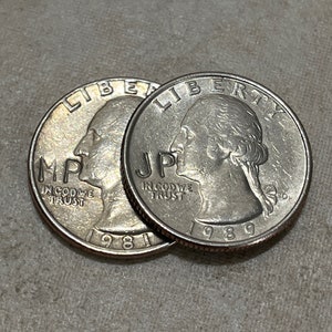May include: Two silver US quarter dollar coins, one from 1981 and the other from 1989, with the words "Liberty" and "In God We Trust" visible.