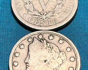 May include: Two silver US five-cent coins, one with the profile of Liberty and the date 1911, the other with the Roman numeral V and the words "United States of America" and "Five Cents".