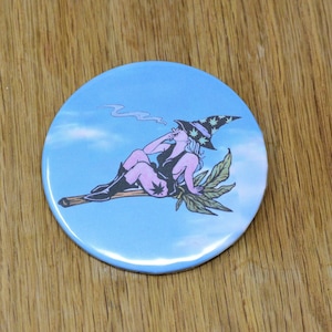 The High Witch on her broom metal pinback button, woman anatomy backpack pin, hat beanie button