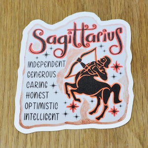 May include: A white sticker with a black and orange illustration of a Sagittarius zodiac sign. The sticker features the text "Sagittarius" in orange lettering and a list of traits: "Independent, Generous, Caring, Honest, Optimistic, Intelligent".