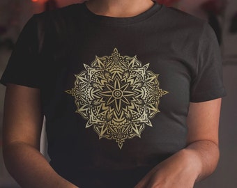 May include: A black t-shirt with a gold mandala design. The mandala is intricate and detailed, with a starburst pattern in the center.