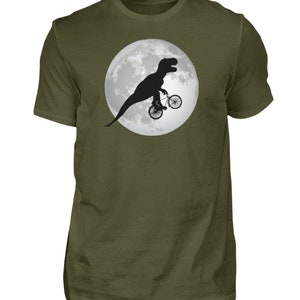 May include: A green t-shirt with a black silhouette of a dinosaur riding a bicycle in front of a full moon.