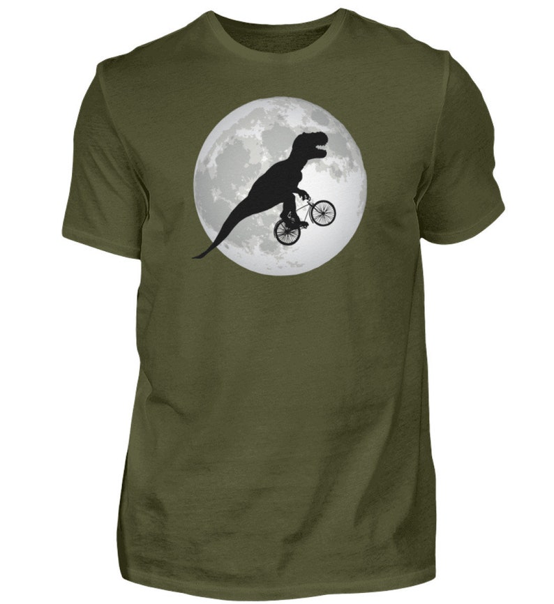 May include: A green t-shirt with a black silhouette of a dinosaur riding a bicycle in front of a full moon.