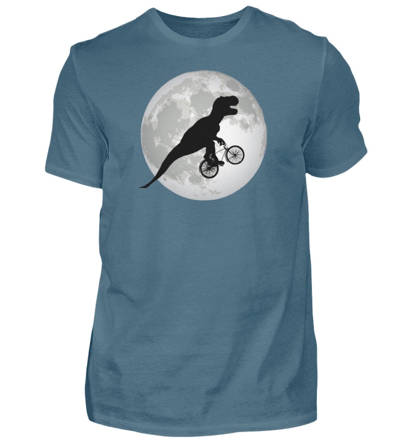 May include: A blue t-shirt with a graphic of a dinosaur riding a bicycle in front of a full moon.