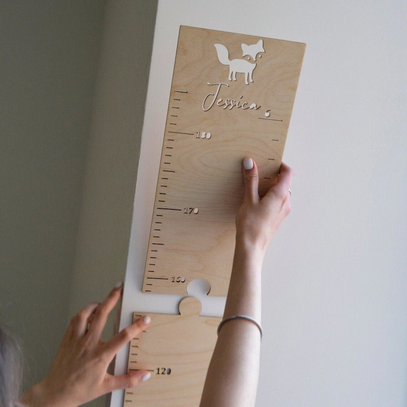 Wood height chart made from natural wood, featuring engraved measurements. Perfect for tracking children's growth over the years, with a simple and elegant design that complements any home decor