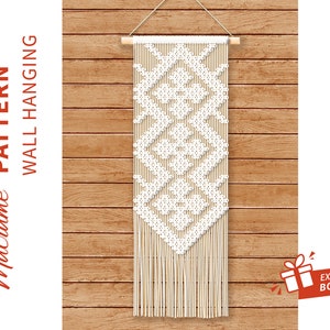 May include: White macrame wall hanging with a geometric diamond pattern, hanging on a wood wall.