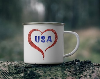 May include: White enamel camping mug with a red heart design and the word "USA" in blue lettering.