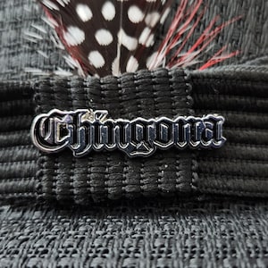 May include: Black hat with a silver metal buckle that says "Chingona".