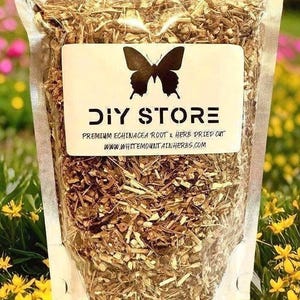 May include: A clear plastic bag filled with dried herbs, labeled "DIY STORE" with a butterfly logo. The label also reads "Premium Echinacea Root & Herb Dried Cut" and a website address. The background features colorful flowers.
