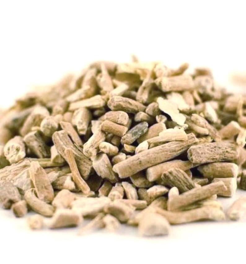 May include: A close-up shot of a collection of dried herbal roots, displaying a range of light brown and beige tones. The roots are of varying sizes and shapes, some cylindrical, others more irregular. The background is plain white, emphasizing the natural texture and colour of the herbs.